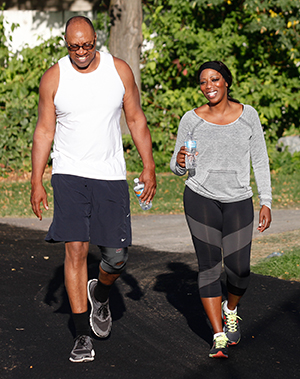 Man and woman walking in park.