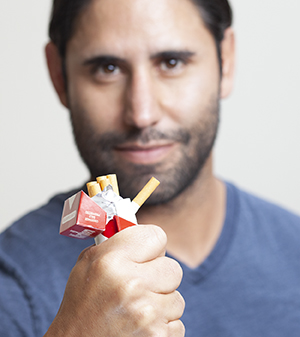 Man crushing cigarettes.